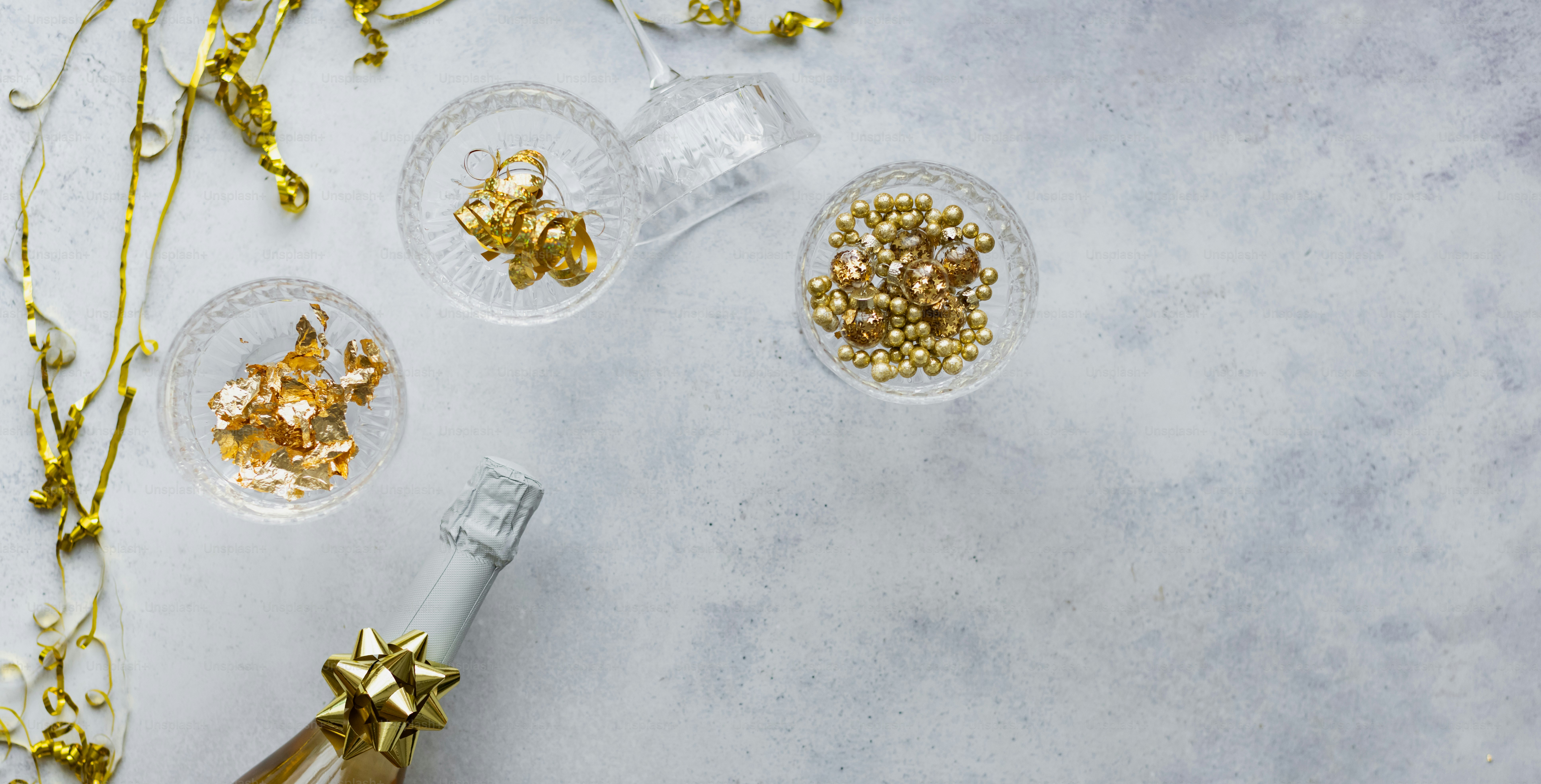 a bottle of champagne next to some gold decorations